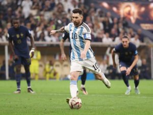 LUSAIL CITY, QATAR - DECEMBER 18: Lionel Messi of Argentina scores the team's first goal from the penalty spot during the FIFA World Cup Qatar 2022 Final match between Argentina and France at Lusail Stadium on December 18, 2022 in Lusail City, Qatar. (Photo by Catherine Ivill/Getty Images)